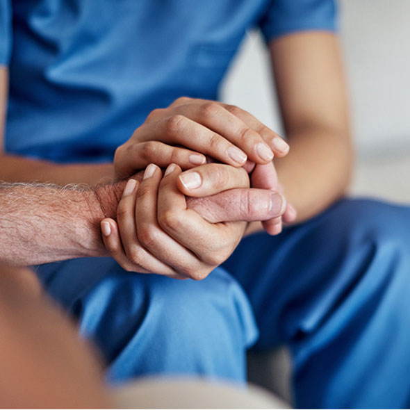 photo of social worker holding hands with patient